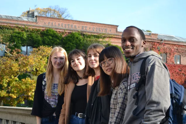 International students posing in front of the Palaestra building. Photo.